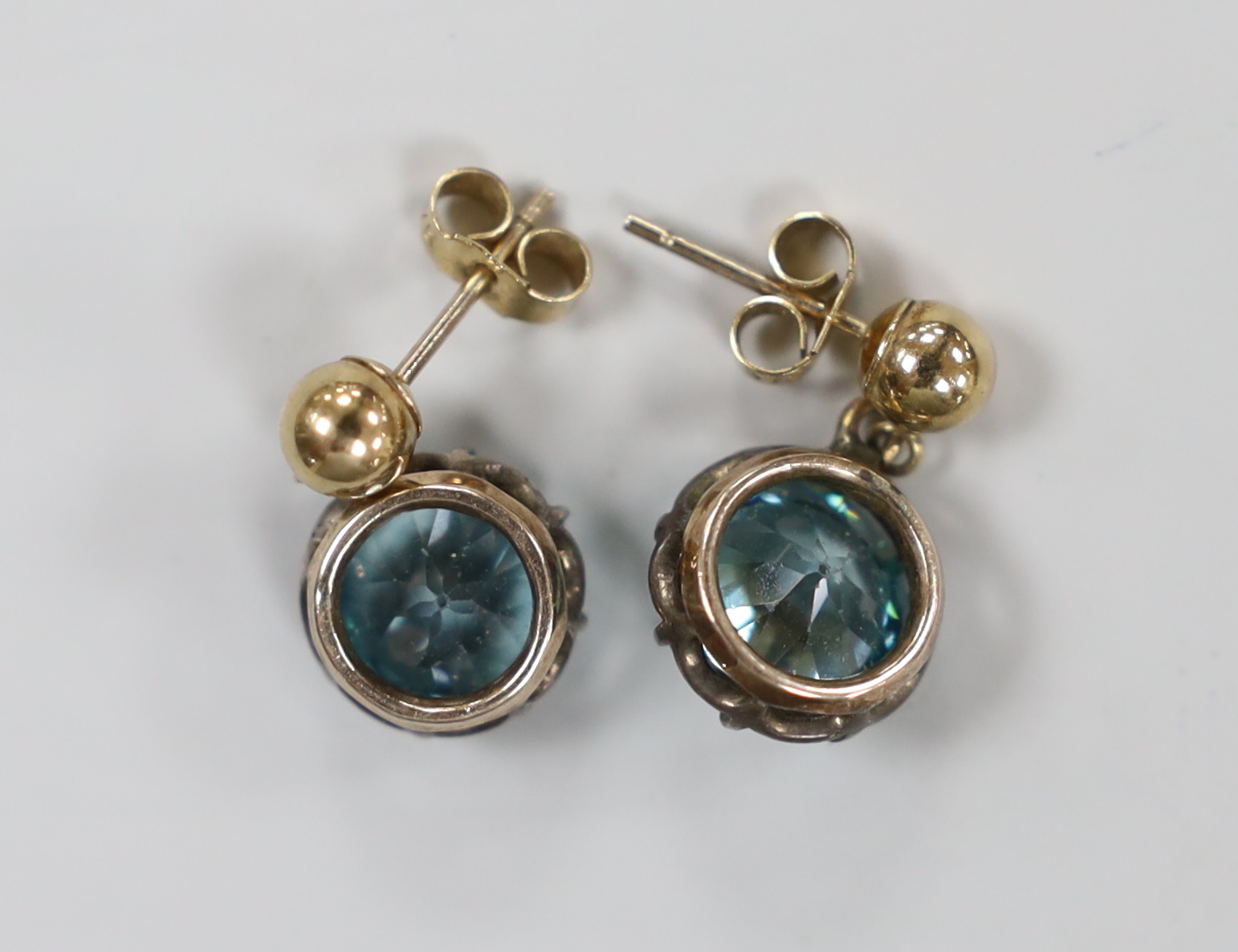 A pair of 375 yellow metal and blue zircon set earrings, 9mm, gross weight 4.4 grams.